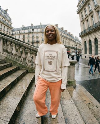 a woman standing on a set of stairs in front of a building