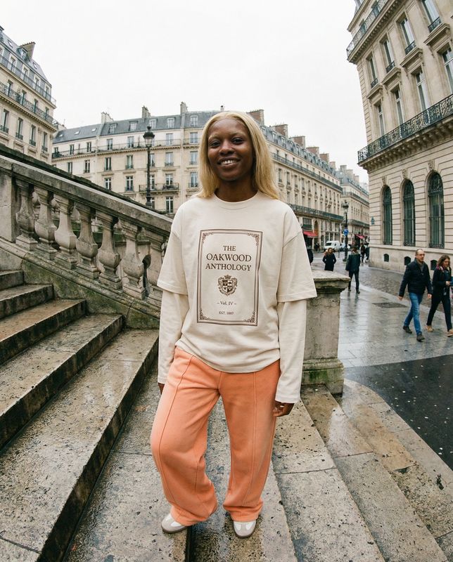 a woman standing on a set of stairs in front of a building