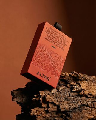 a red box sitting on top of a piece of wood