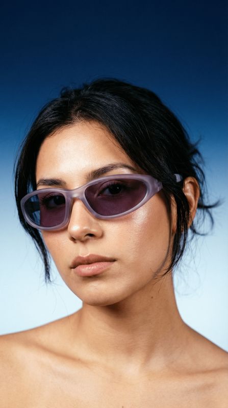 a woman wearing a pair of purple sunglasses