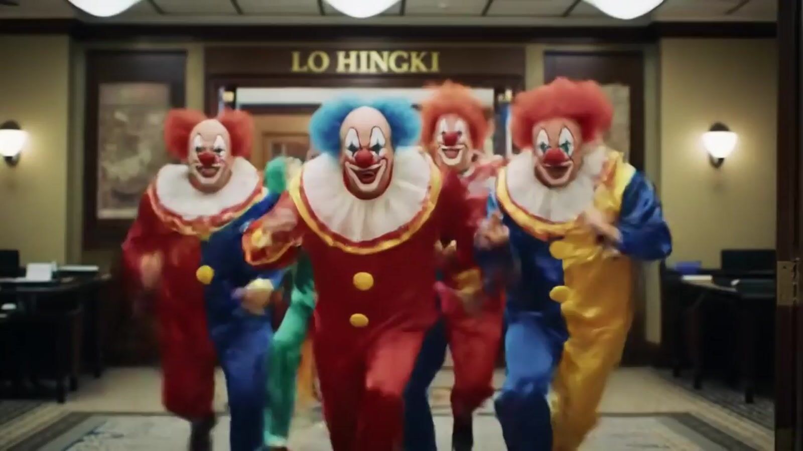 a group of clowns walking down a hallway