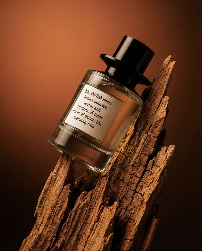 a bottle of perfume sitting on top of a piece of wood