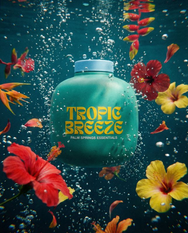 a bottle floating in the water surrounded by flowers