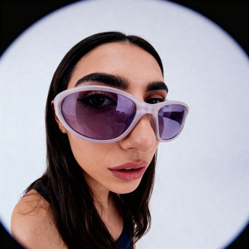a woman wearing a pair of purple sunglasses