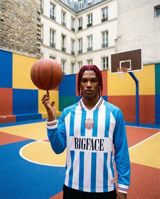 a man with dreadlocks holding a basketball