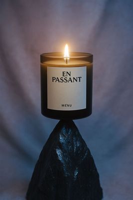 a candle that is on top of a rock