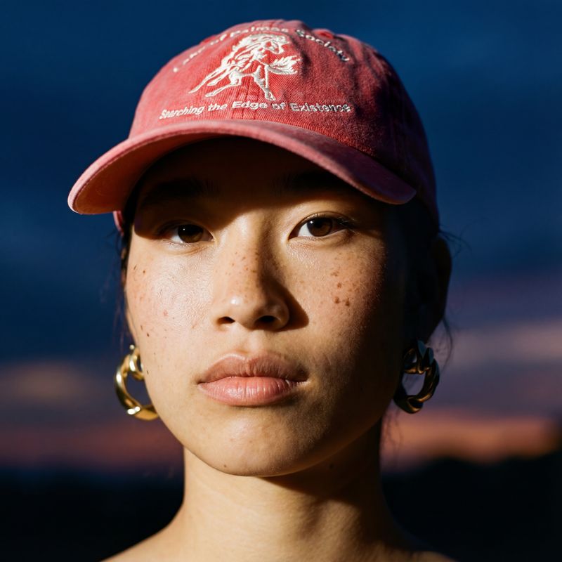 a woman wearing a red hat and earrings