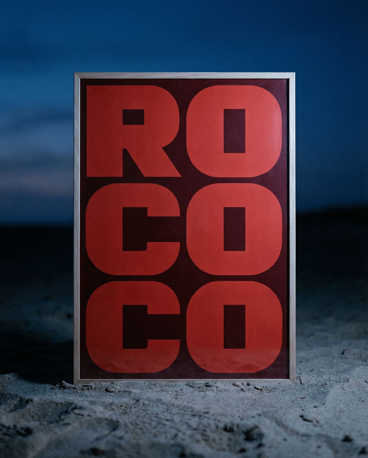 a red and black sign sitting in the sand