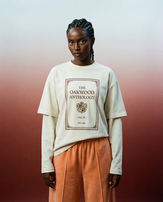 a woman standing in front of a red and white background