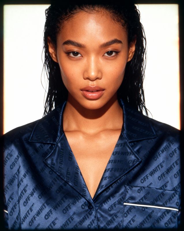 a woman with a ponytail wearing a blue shirt