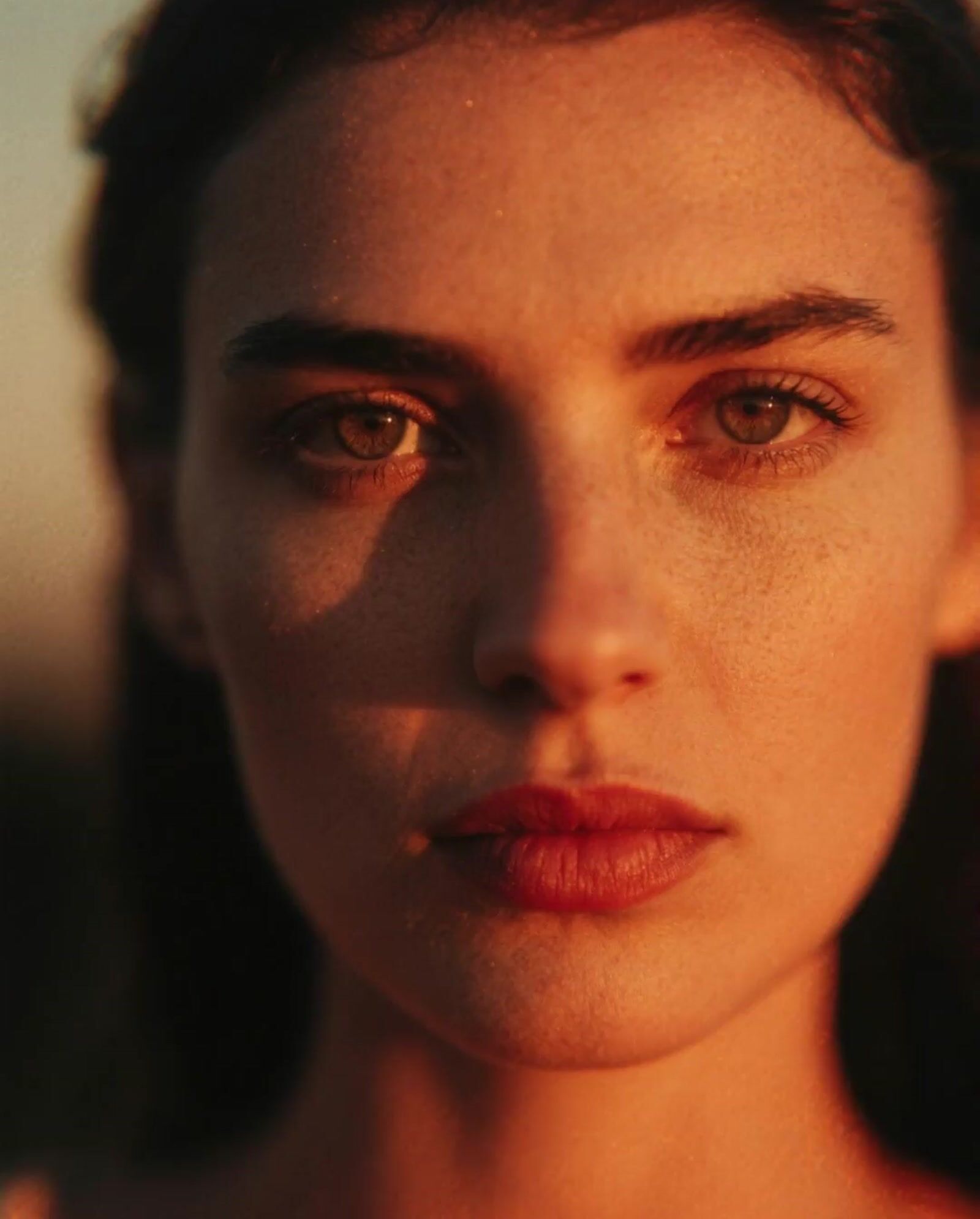 a close up of a woman's face with brown eyes