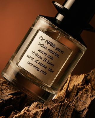 a bottle of perfume sitting on top of a wooden table