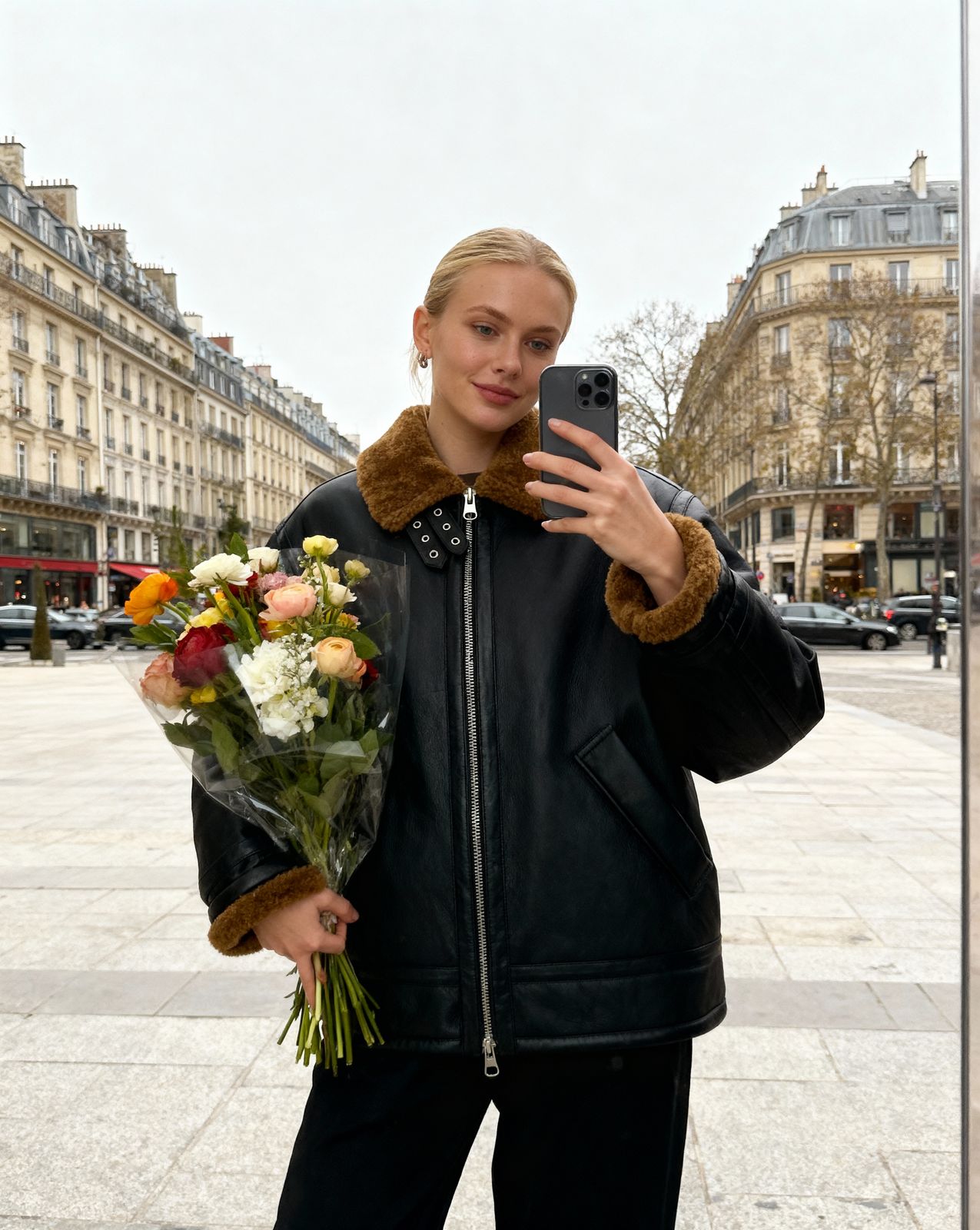 a woman taking a picture of herself with her phone