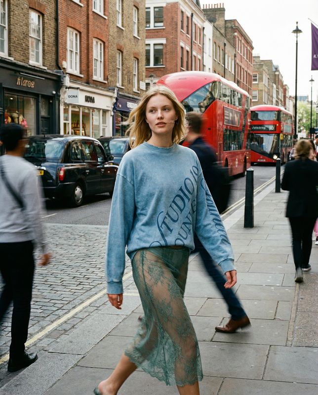 a woman walking down the street in a skirt