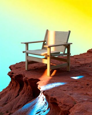 a wooden chair sitting on top of a rocky cliff