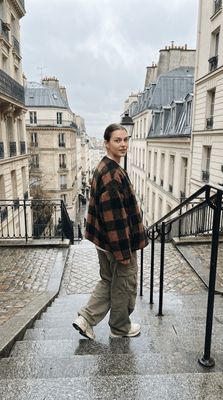 a woman walking down a set of stairs