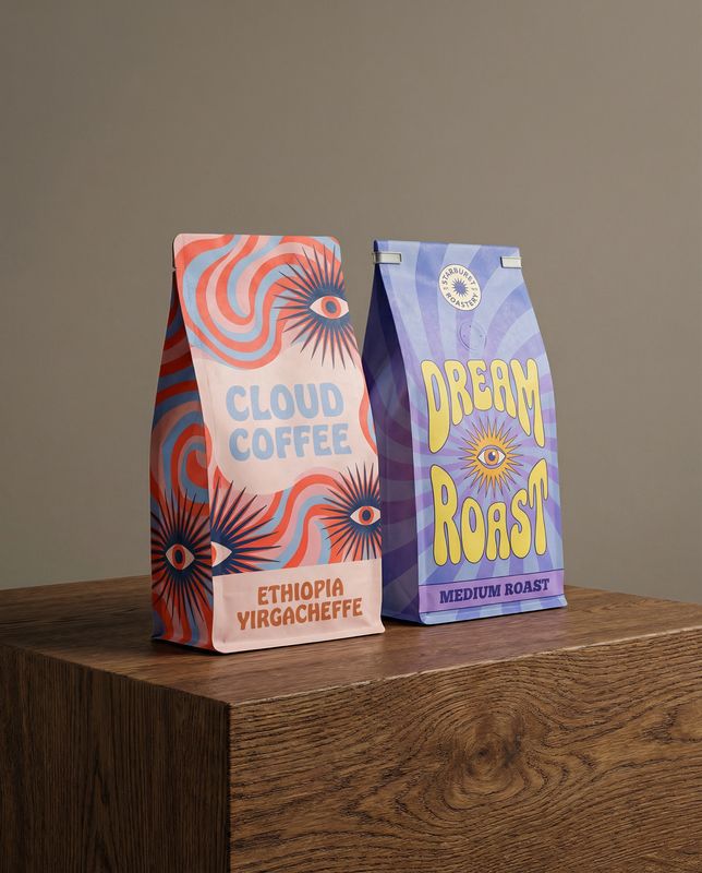 two bags of coffee sitting on top of a wooden table