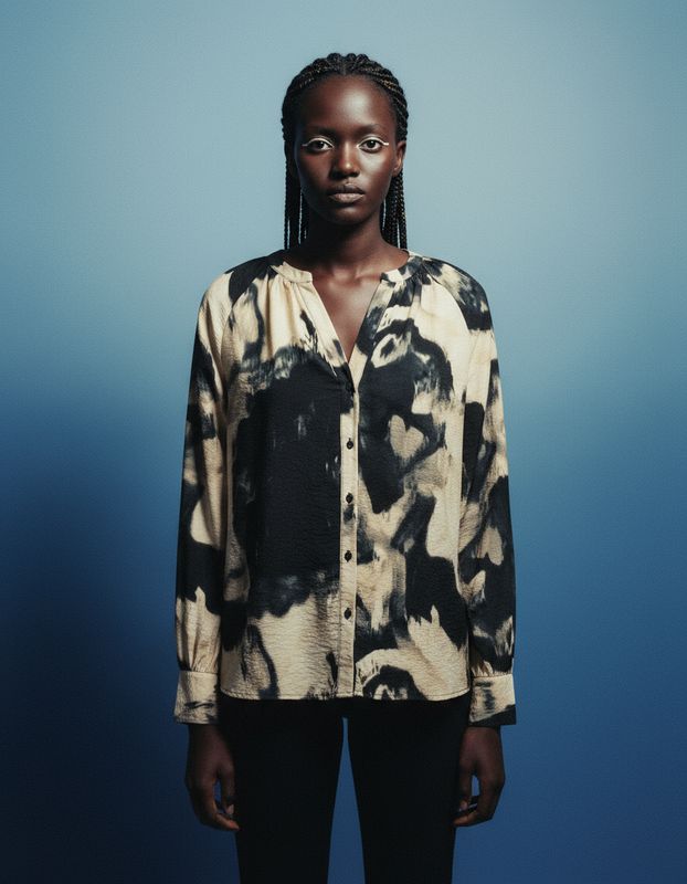 a woman standing in front of a blue background