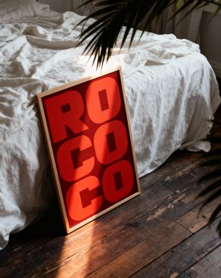 a red sign sitting on top of a wooden floor