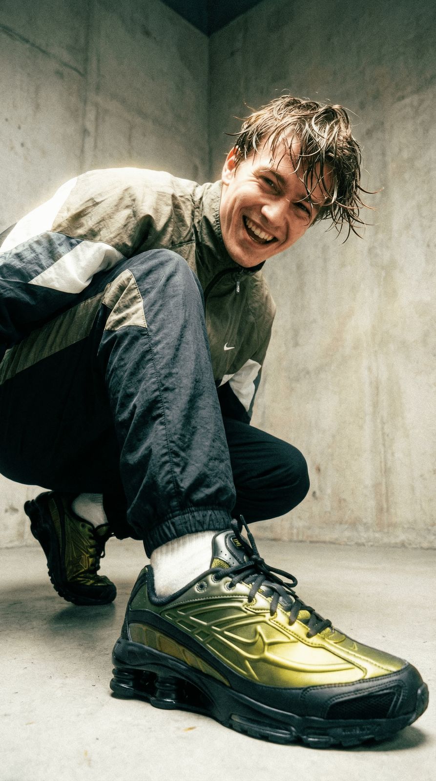 a man kneeling down next to a yellow shoe