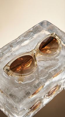 a pair of sunglasses sitting on top of an ice block