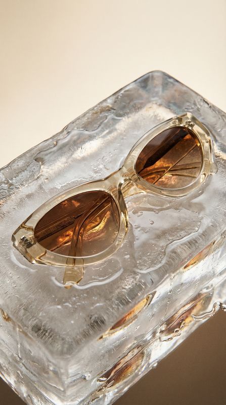 a pair of sunglasses sitting on top of an ice block