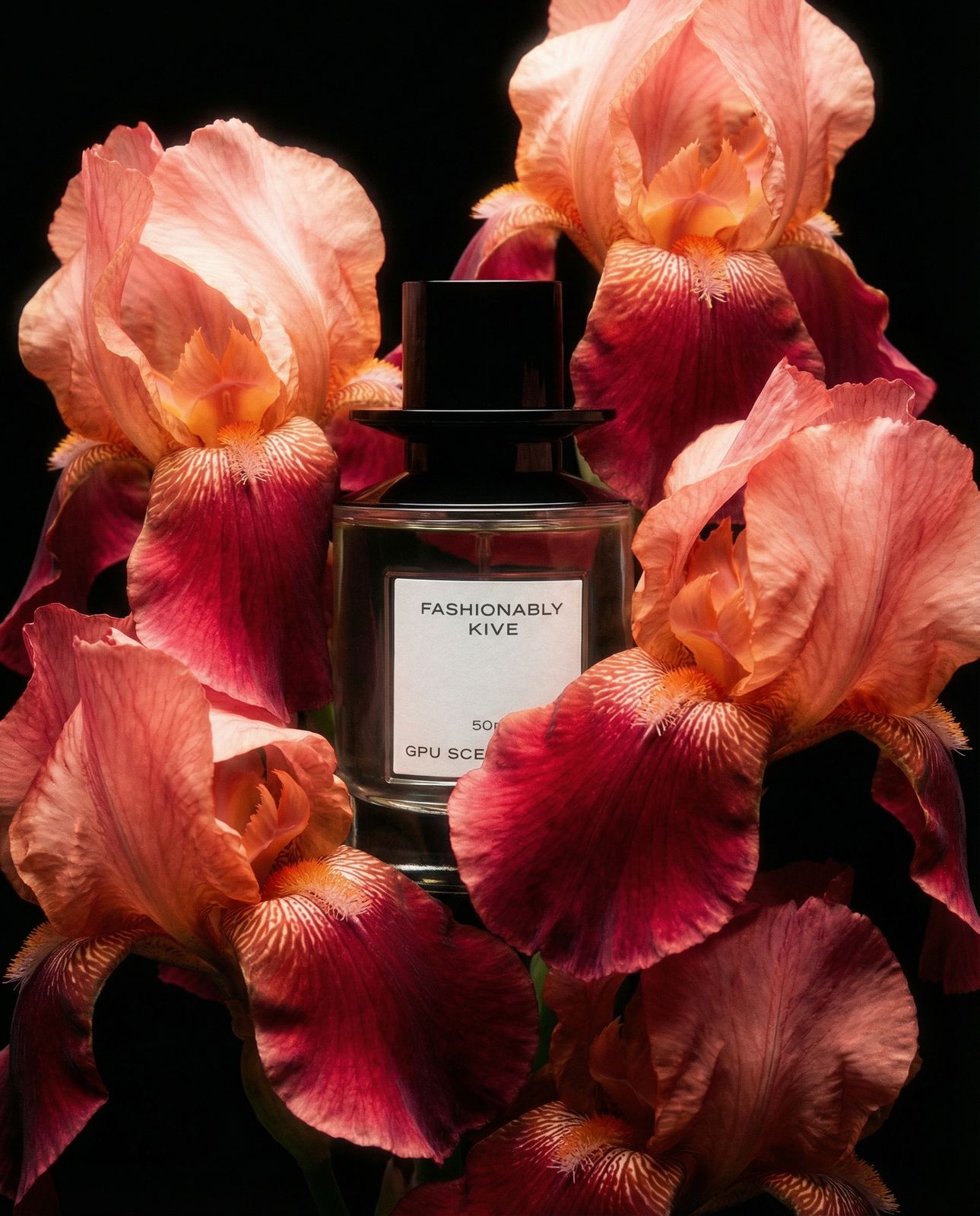 a close up of a bottle of perfume surrounded by flowers