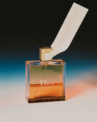 a bottle of dior perfume with a paper sticking out of it
