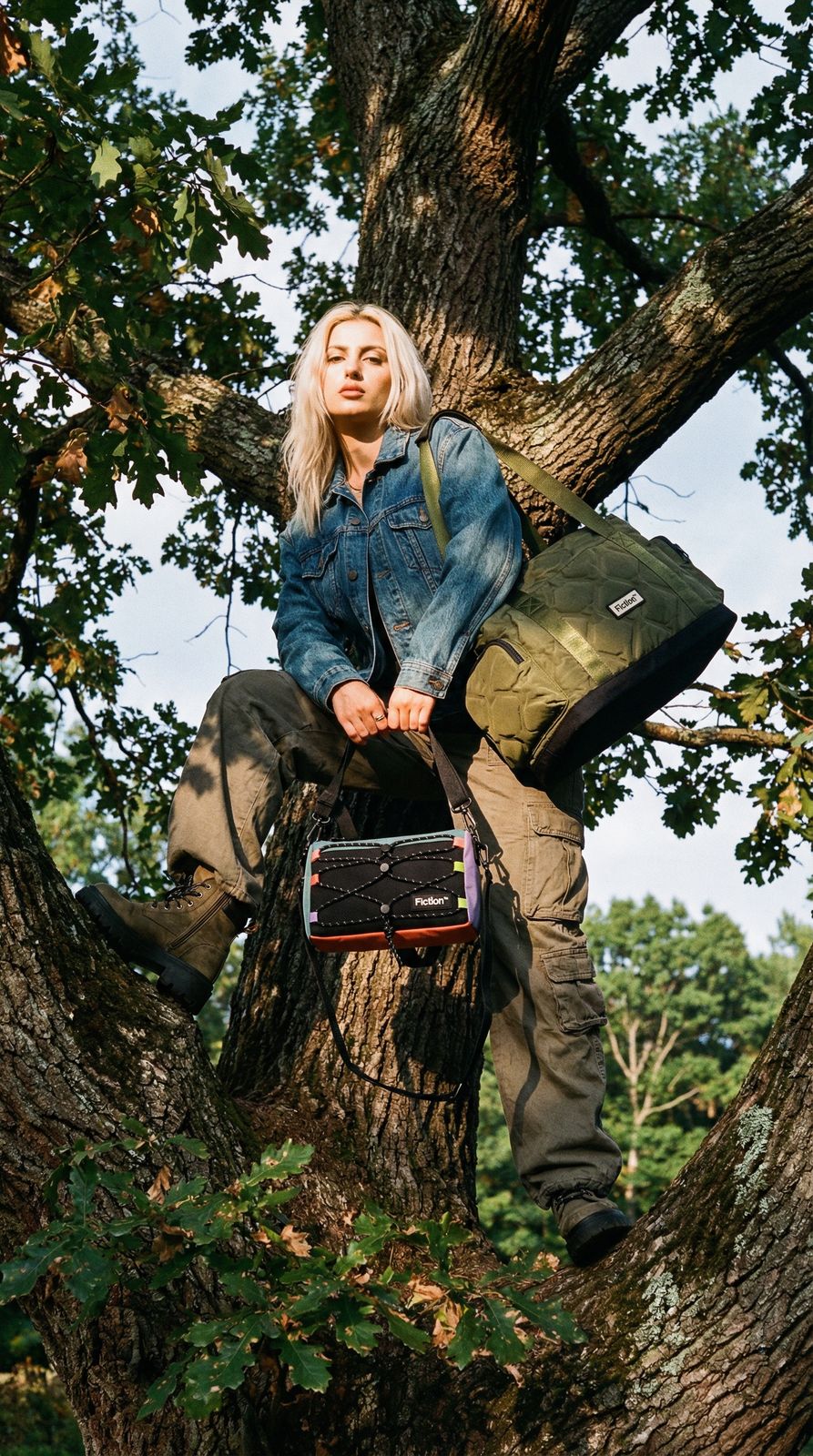 a woman sitting in a tree with a suitcase