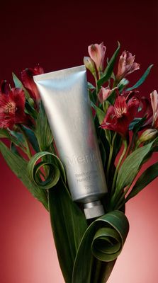 a vase filled with flowers and a tube of cream