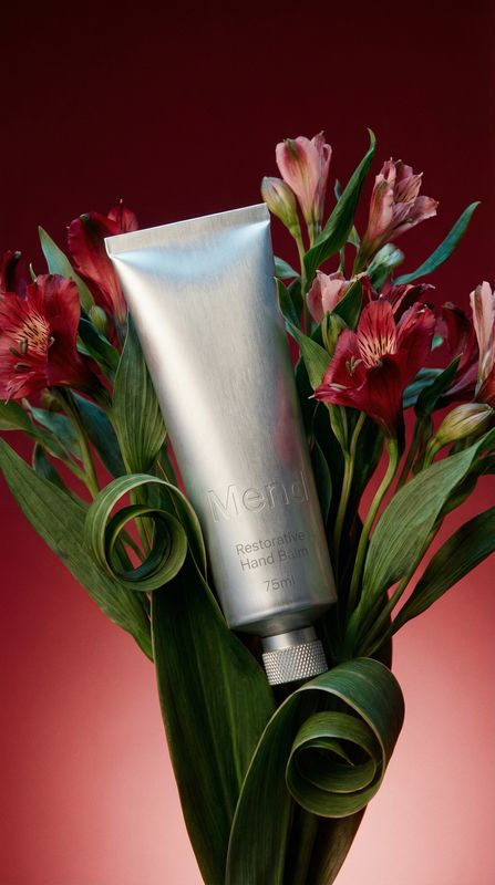 a vase filled with flowers and a tube of cream