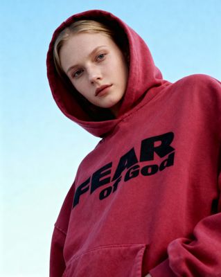 a woman wearing a red hoodie with the word fear on it