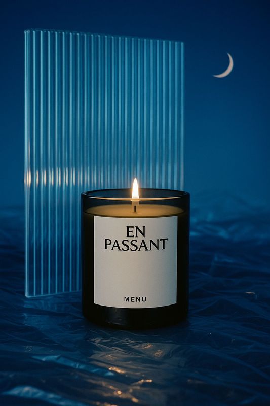 a lit candle sitting on top of a table