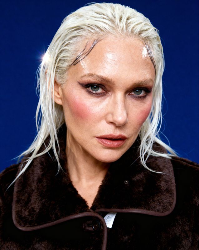 a close up of a person wearing a fur coat