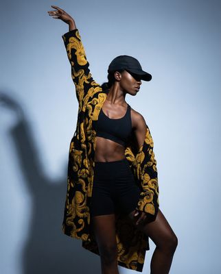 a woman in a black and yellow jacket and shorts