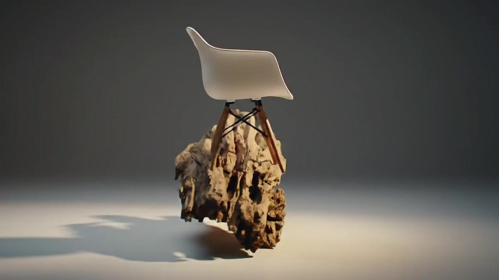 a white chair sitting on top of a piece of wood