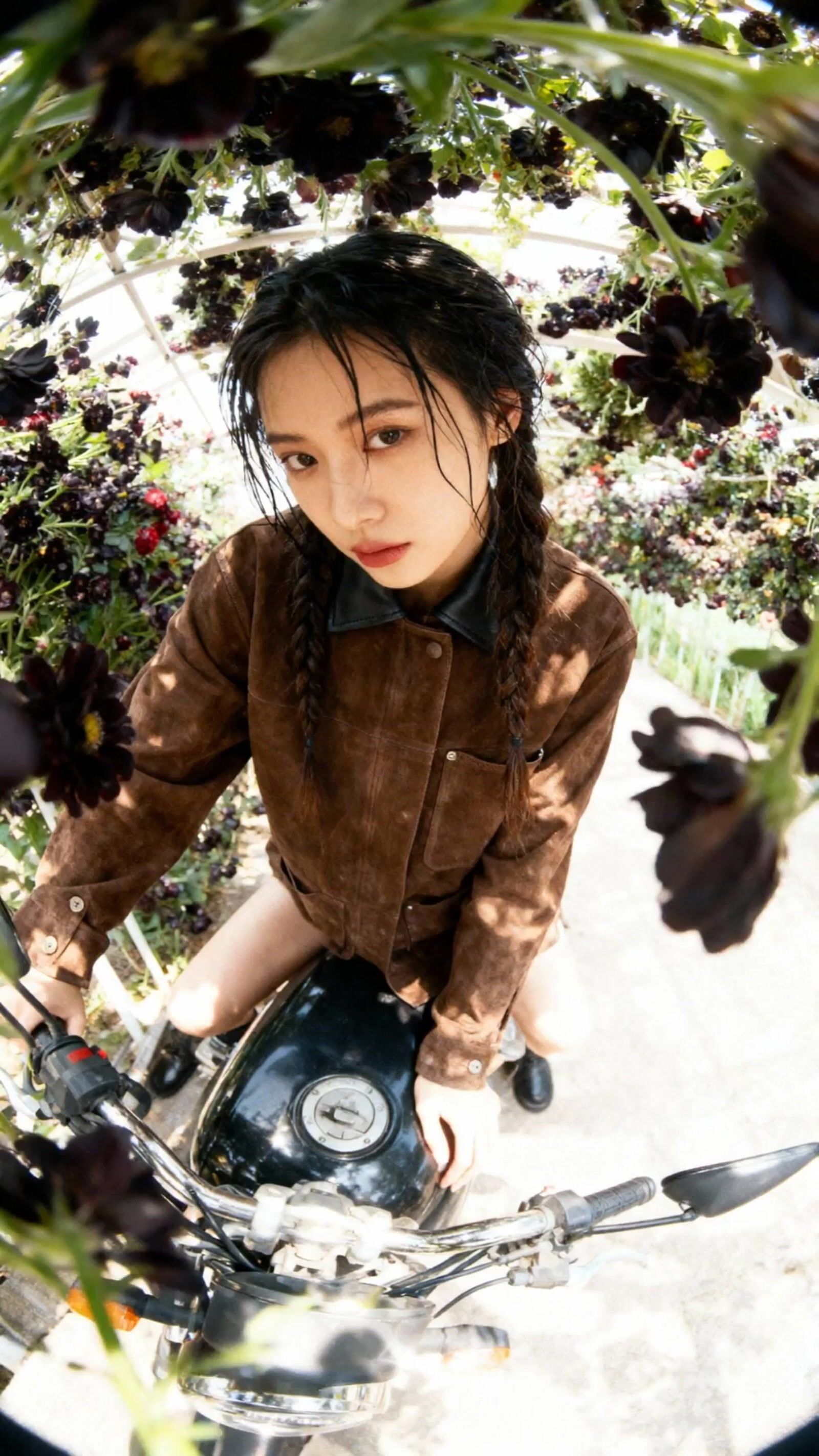 a woman riding on the back of a motorcycle