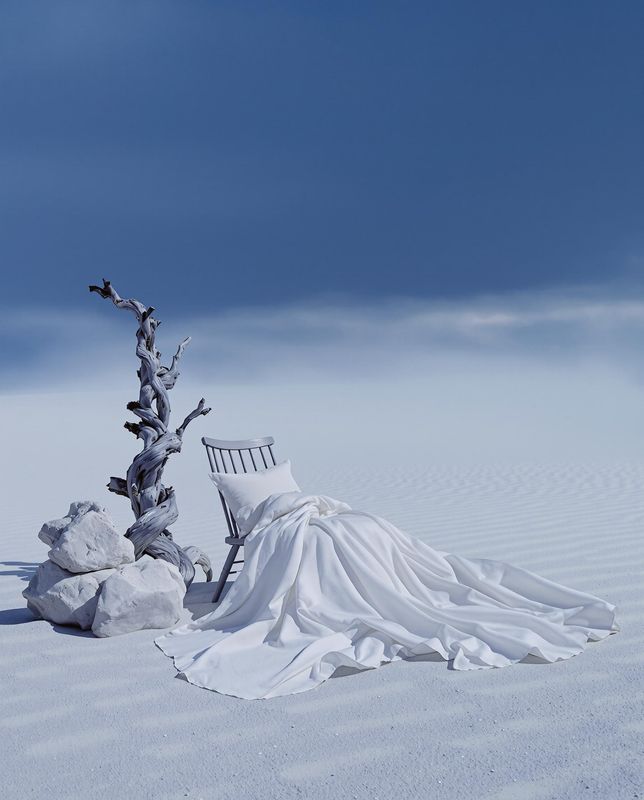 a chair sitting on top of a snow covered field