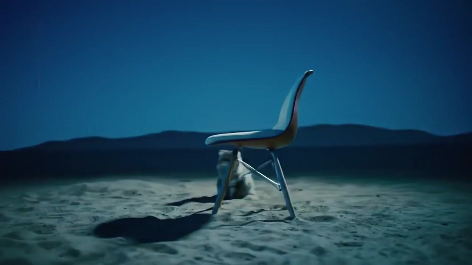 a chair sitting on top of a sandy beach
