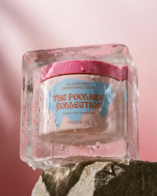 a bottle of foot scrub sitting on top of a rock