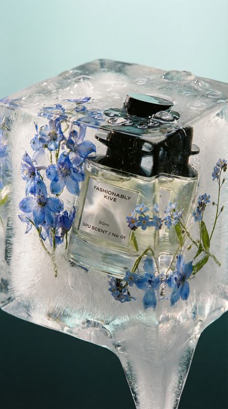 a bottle of perfume sitting on top of an ice block