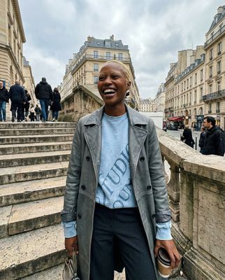 a woman standing in front of some steps
