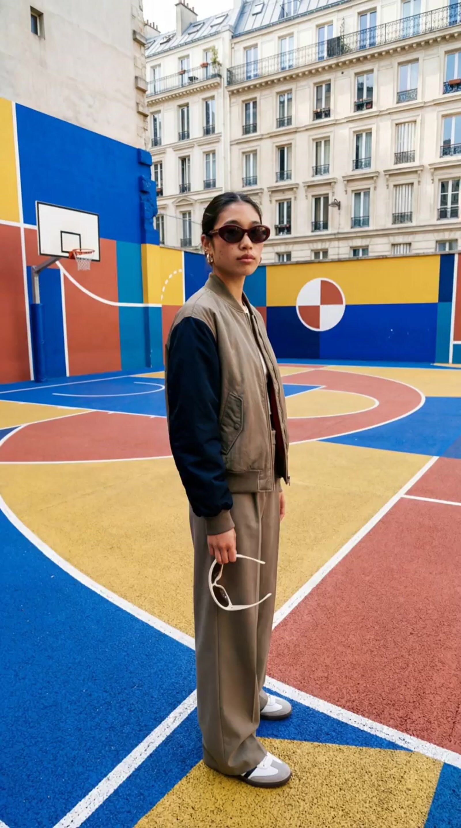 a woman standing in front of a basketball court