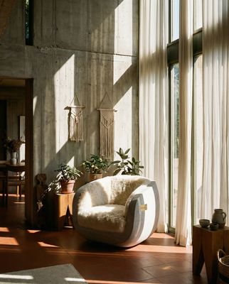 a living room filled with furniture and lots of windows