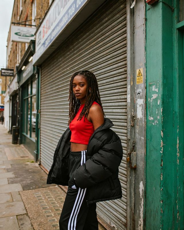 a woman standing in front of a building
