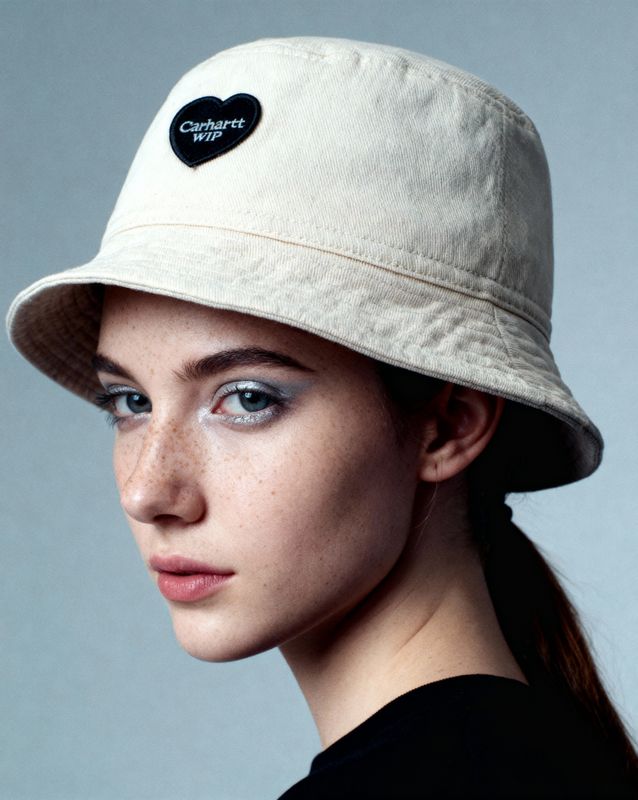 a woman wearing a hat with a heart on it