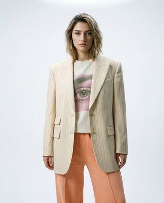 a woman in a white jacket and orange pants