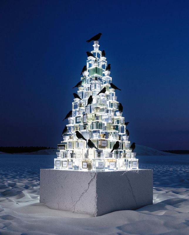 a christmas tree made of glass blocks in the snow