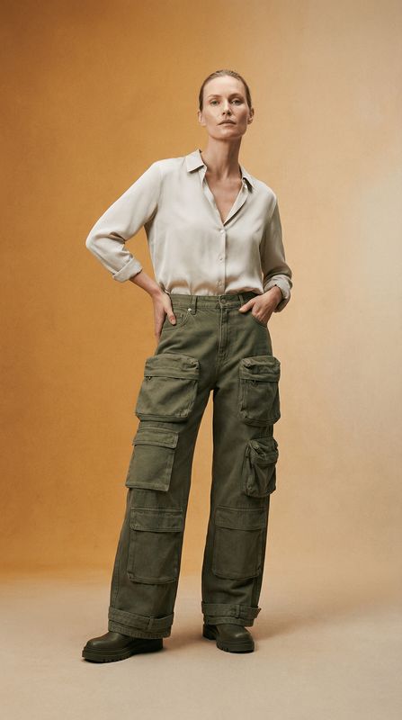 a woman standing with her hands on her hips