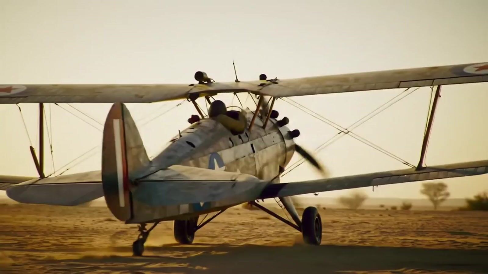 a small airplane sitting on top of a dirt field